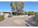 Beautiful backyard featuring a large tree providing shade and a patio area perfect for outdoor entertaining at 11029 W Palmeras Dr, Sun City, AZ 85373