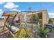 Backyard with mature plants, swing and white picket fence at 11596 W Sierra Dawn Blvd # 278, Surprise, AZ 85378
