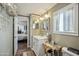 Inviting bathroom with a single sink vanity, framed mirror, and view to an adjacent bedroom at 11596 W Sierra Dawn Blvd # 278, Surprise, AZ 85378