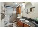 Stylish bathroom with a single sink vanity, a framed circular mirror, and a walk-in shower at 11596 W Sierra Dawn Blvd # 278, Surprise, AZ 85378