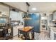 Charming kitchen features custom cabinets, kitchen island with rustic metal accents, and updated appliances at 11596 W Sierra Dawn Blvd # 278, Surprise, AZ 85378