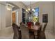 Dining room featuring an elegant chandelier, large windows with scenic views, and comfortable seating at 12276 N 129Th St, Scottsdale, AZ 85259