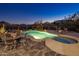 Outdoor entertaining at its finest with a sparkling pool, spa, desert landscaping, and mountain views under the night sky at 12276 N 129Th St, Scottsdale, AZ 85259