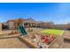 Backyard featuring a sandbox, playground, artificial turf and string lights for outdoor fun at 12344 E Soloman Rd, Gold Canyon, AZ 85118