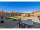 Spacious backyard with gravel, artificial turf, and a seating area under hanging lights at 12344 E Soloman Rd, Gold Canyon, AZ 85118