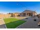 Spacious backyard with artificial turf, a seating area under hanging lights, and a playground at 12344 E Soloman Rd, Gold Canyon, AZ 85118