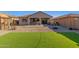 A backyard featuring artificial turf, a patio, and a playground at 12344 E Soloman Rd, Gold Canyon, AZ 85118