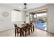 Bright dining area with a wooden table, seating for six, and sliding glass doors to the patio at 12344 E Soloman Rd, Gold Canyon, AZ 85118