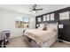 Cozy main bedroom with a ceiling fan and black accent wall at 12344 E Soloman Rd, Gold Canyon, AZ 85118