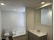 Well-lit bathroom featuring a combination tub and shower, toilet, and a modern vanity with a sleek mirror at 12814 N 19Th Pl # 19, Phoenix, AZ 85022