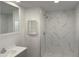 Bathroom featuring modern vanity, wall mirrors, and a sleek walk-in shower with elegant marble-style tiling at 12814 N 19Th Pl # 19, Phoenix, AZ 85022