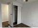 Bedroom showcasing an open closet, wood floors, and neutral walls at 12814 N 19Th Pl # 19, Phoenix, AZ 85022