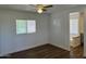 Cozy bedroom with new floors, a window for natural light, and a glimpse of an en-suite bathroom at 12814 N 19Th Pl # 19, Phoenix, AZ 85022