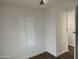 Bedroom featuring wood floors, a ceiling fan, neutral walls, and a window with blinds at 12814 N 19Th Pl # 19, Phoenix, AZ 85022