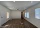 Spacious living room featuring new wood-look floors, neutral paint, and a ceiling fan at 12814 N 19Th Pl # 19, Phoenix, AZ 85022