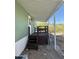 A raised, covered patio has stairs with wood railing leading down to the yard at 12814 N 19Th Pl # 19, Phoenix, AZ 85022