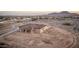 Aerial view of a single Gathering home with desert landscape and a scenic mountain backdrop at 12942 S 218Th Ave, Buckeye, AZ 85326