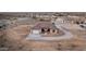 Areal view of home with neutral stucco exterior, tile roof, two-car garage, and simple landscaping at 12942 S 218Th Ave, Buckeye, AZ 85326