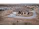 High angle view of single Gathering home, gravel driveway, two car garage and desert landscape at 12942 S 218Th Ave, Buckeye, AZ 85326