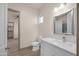 Well-lit bathroom with marble countertops, modern fixtures, and seamless access to the spacious closet at 12942 S 218Th Ave, Buckeye, AZ 85326