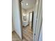 Bright bathroom featuring wood floors, a white vanity with a marble countertop, and neutral paint at 12942 S 218Th Ave, Buckeye, AZ 85326