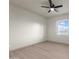 Inviting bedroom featuring modern floors, ample natural light from the windows and contemporary ceiling fan at 12942 S 218Th Ave, Buckeye, AZ 85326