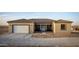 Inviting home featuring a neutral stucco exterior, tile roof, and attached two-car garage at 12942 S 218Th Ave, Buckeye, AZ 85326
