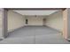 View of spacious two car garage with concrete flooring and door to interior at 12942 S 218Th Ave, Buckeye, AZ 85326