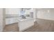 Modern kitchen featuring white cabinetry, stainless steel appliances, a large island, and a window with scenic views at 12942 S 218Th Ave, Buckeye, AZ 85326