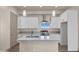 Modern kitchen featuring white cabinetry, stainless steel appliances, a large island, and a window with scenic views at 12942 S 218Th Ave, Buckeye, AZ 85326
