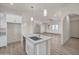 Bright, open kitchen with an island and modern countertops, seamlessly connecting to the expansive living area at 12942 S 218Th Ave, Buckeye, AZ 85326