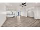 Open-concept floor plan with wood-style floors, white walls, and modern ceiling fan at 12942 S 218Th Ave, Buckeye, AZ 85326