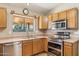 Modern kitchen featuring stainless steel appliances, wood cabinetry, and a view to the outside at 1307 E Galvin St, Phoenix, AZ 85086