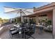 Backyard patio set up for outdoor dining and lounging, with shade and comfortable seating at 14218 W Via Tercero --, Sun City West, AZ 85375