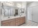 Bathroom featuring double sinks, ample lighting, and a mirrored wall at 14218 W Via Tercero --, Sun City West, AZ 85375