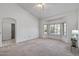 Large carpeted bedroom with bay window, vaulted ceiling, and walk-in closet perfect for relaxing and organizing belongings at 14218 W Via Tercero --, Sun City West, AZ 85375
