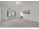 Primary bedroom with vaulted ceiling, bay windows with plantation shutters, and neutral carpet offering lots of natural light at 14218 W Via Tercero --, Sun City West, AZ 85375