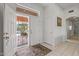 Bright entry foyer featuring tile flooring, white walls, and a security screen door for added safety at 14218 W Via Tercero --, Sun City West, AZ 85375