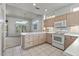 Bright kitchen with tile flooring, white appliances, and island with countertop space and plenty of cabinet storage at 14218 W Via Tercero --, Sun City West, AZ 85375