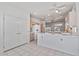 Well-lit kitchen with tile flooring, ample counter space, an island, and a double-door pantry for extra storage space at 14218 W Via Tercero --, Sun City West, AZ 85375