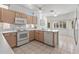 Bright kitchen features wooden cabinetry, white appliances, and ample counter space, perfect for meal prep at 14218 W Via Tercero --, Sun City West, AZ 85375
