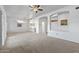 Expansive living room showcases neutral carpet, arched accents, with kitchen views, promoting open living at 14218 W Via Tercero --, Sun City West, AZ 85375
