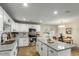 Modern kitchen with granite countertops, stainless steel appliances, white cabinetry, and eat-in dining area at 14436 N 34Th Pl, Phoenix, AZ 85032