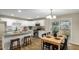 Eat-in kitchen features a large island, granite counters, stainless appliances, and an adjacent dining area at 14436 N 34Th Pl, Phoenix, AZ 85032