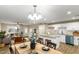 Bright open floor plan with a modern kitchen, granite counters, stainless steel appliances, and breakfast bar at 14436 N 34Th Pl, Phoenix, AZ 85032