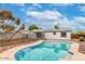 Backyard with pool, rock landscaping, secure fencing, and view of back of house at 14436 N 34Th Pl, Phoenix, AZ 85032