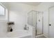 Bright bathroom features a walk-in shower, a large garden tub, and a window for natural light at 14610 N 87Th Ave, Peoria, AZ 85381