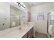 Bright bathroom features a single sink vanity, a walk-in shower, and a window for natural light at 14610 N 87Th Ave, Peoria, AZ 85381