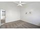 Bedroom features neutral carpet, a ceiling fan, natural light, and ensuite access to a bathroom at 14610 N 87Th Ave, Peoria, AZ 85381