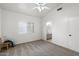 The bedroom features neutral carpet, a ceiling fan, natural light, and ensuite access at 14610 N 87Th Ave, Peoria, AZ 85381